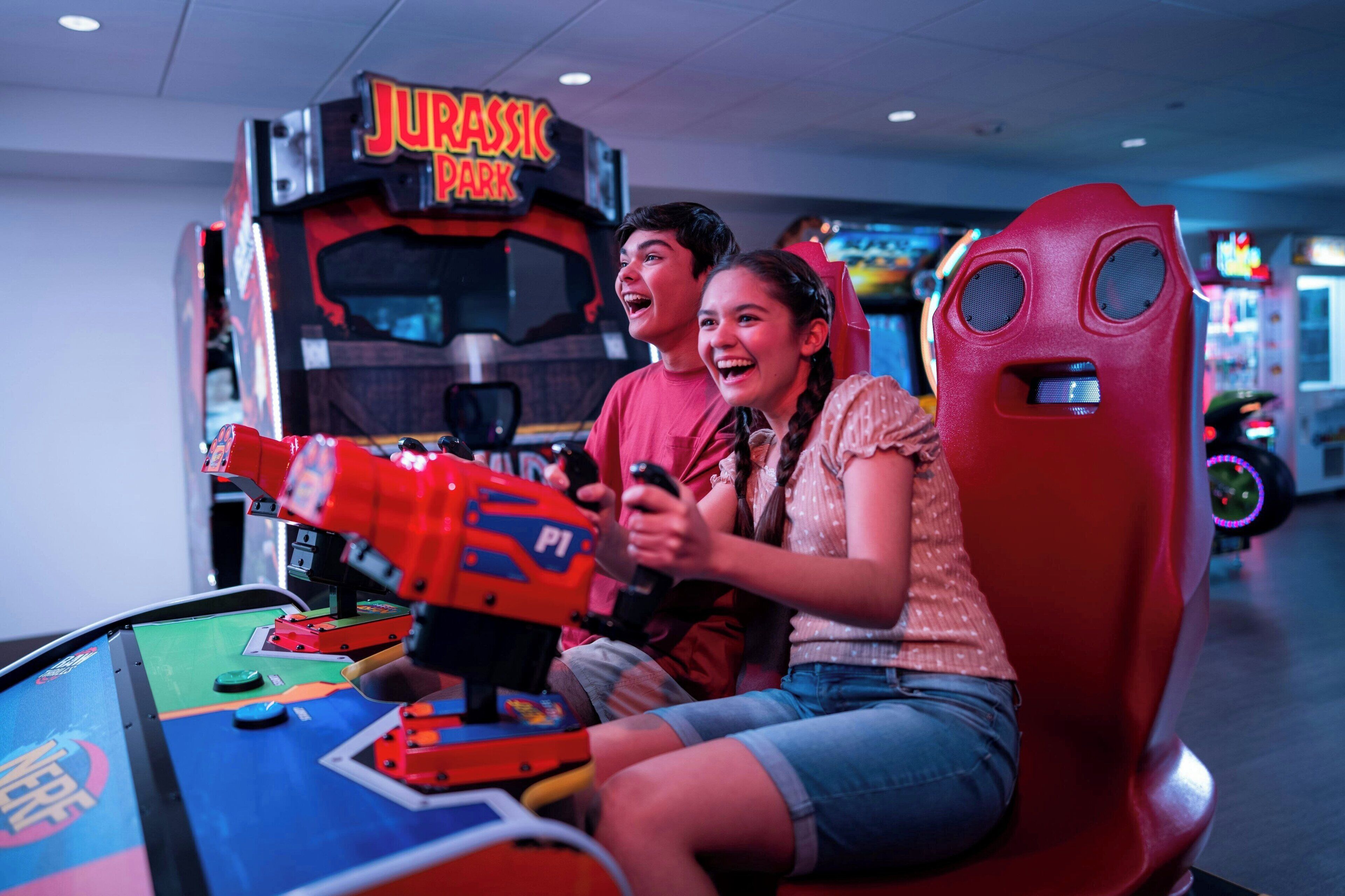 A gaming arcade with a 'Jurassic Park' themed game.