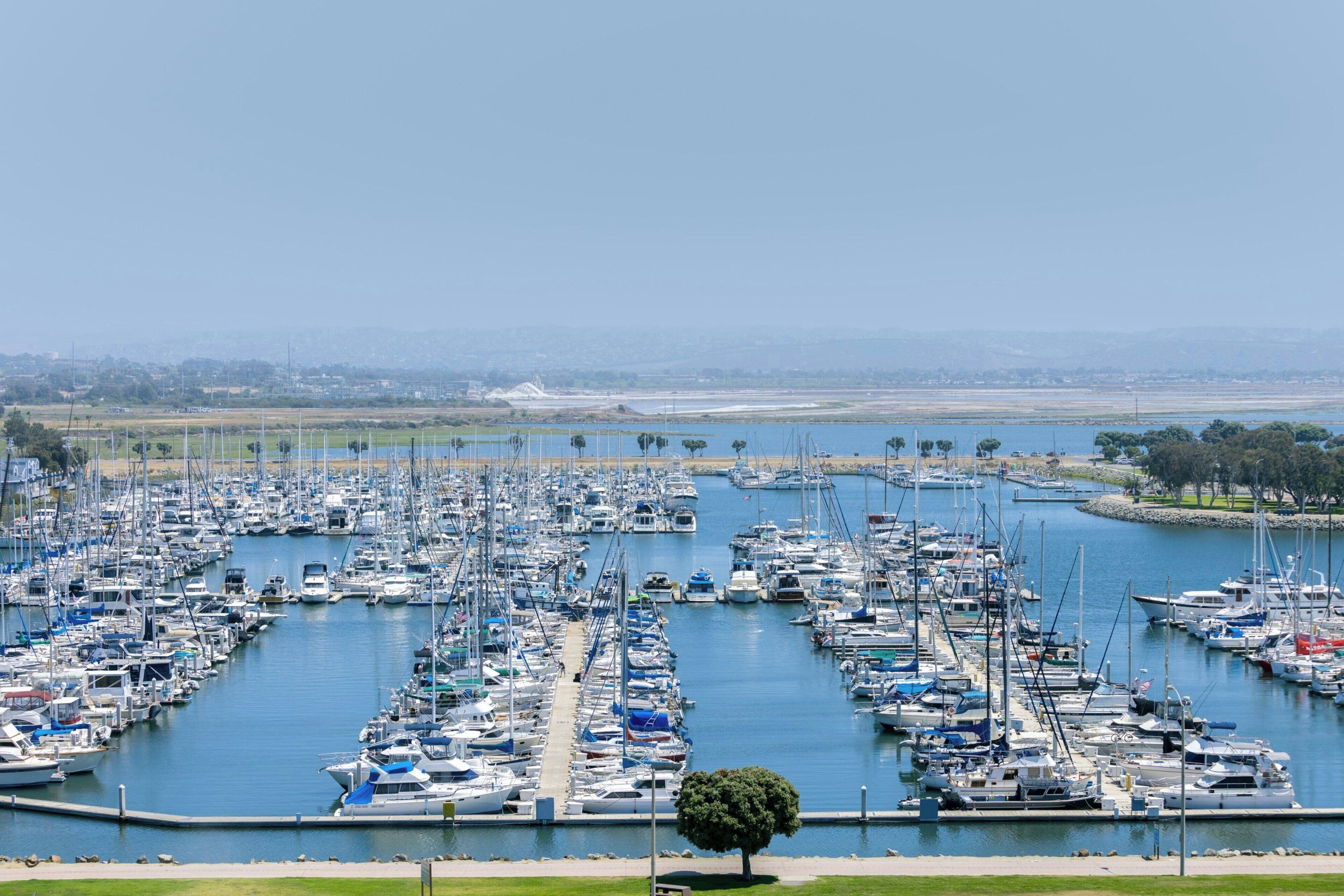 A marina with numerous boats docked in a large, organized harbor.