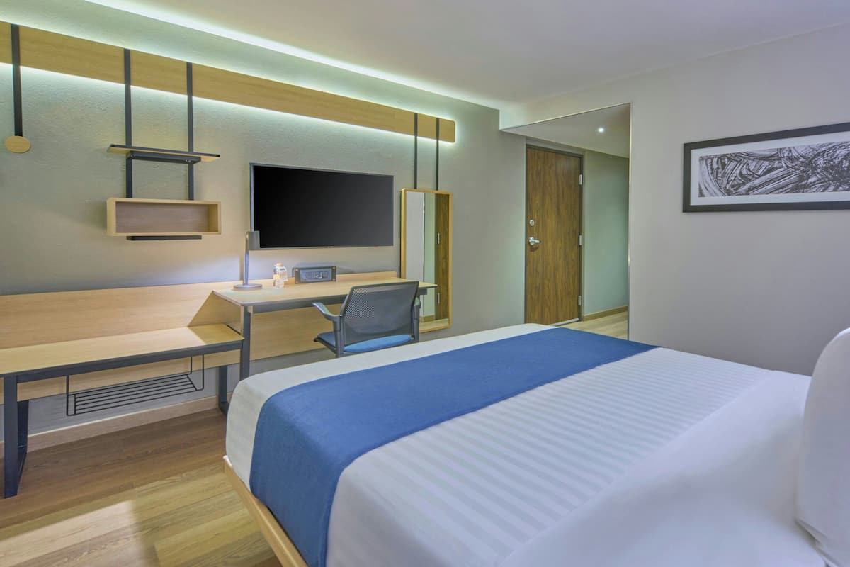 Escritorio, cortinas blackout y tabla de planchar con plancha