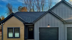 Une maison à deux étages avec un garage, une porte d’entrée et le numéro « 101 » sur le côté.