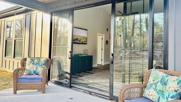 Une maison moderne dotée d’une porte-fenêtre coulissante qui donne sur un intérieur spacieux.