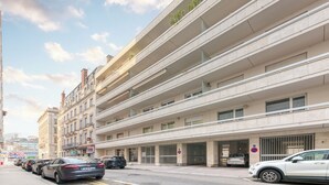 A multi-story parking garage with a modern design, featuring a series of balconies and large windows.