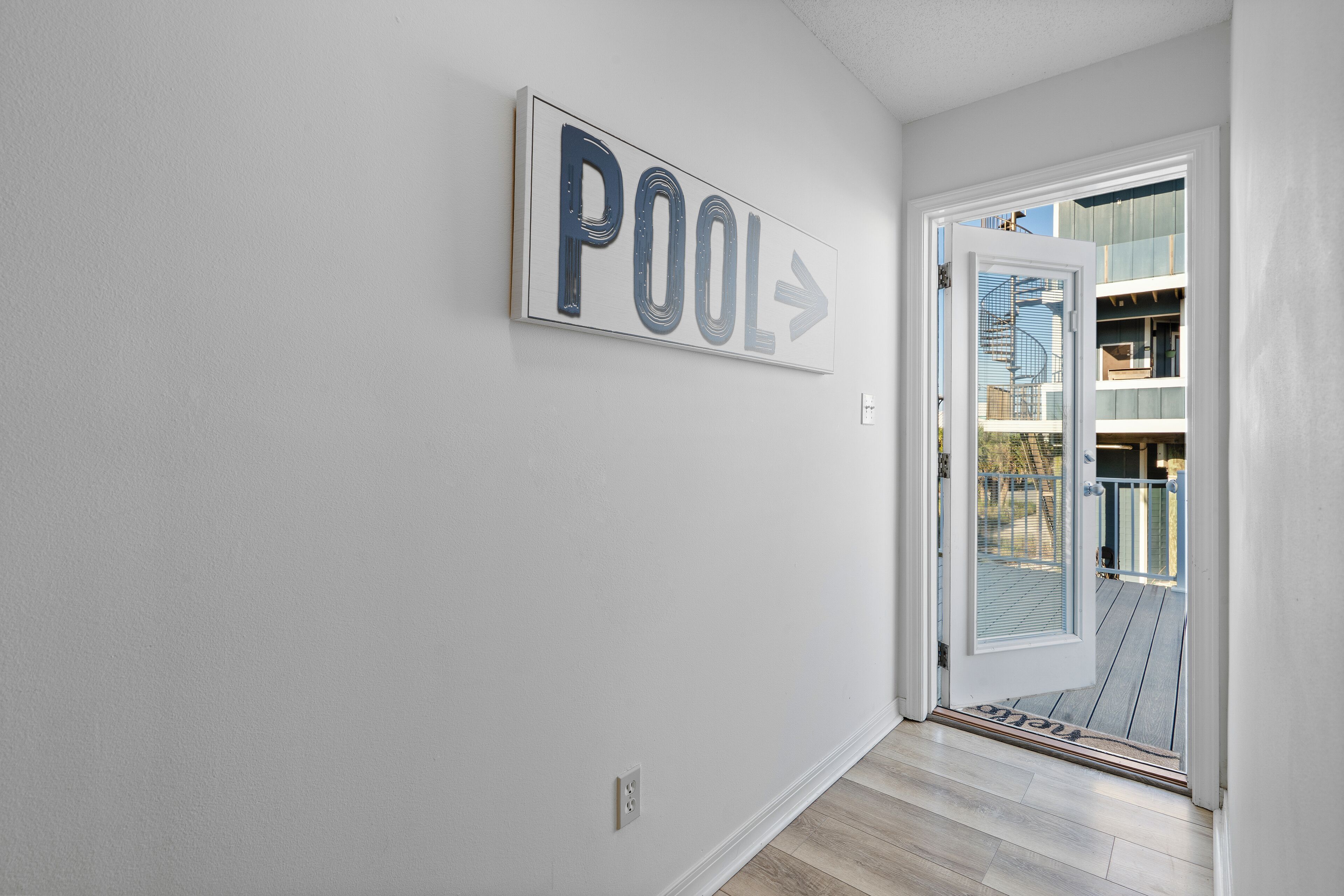 A hallway with a sign indicating a pool direction.
