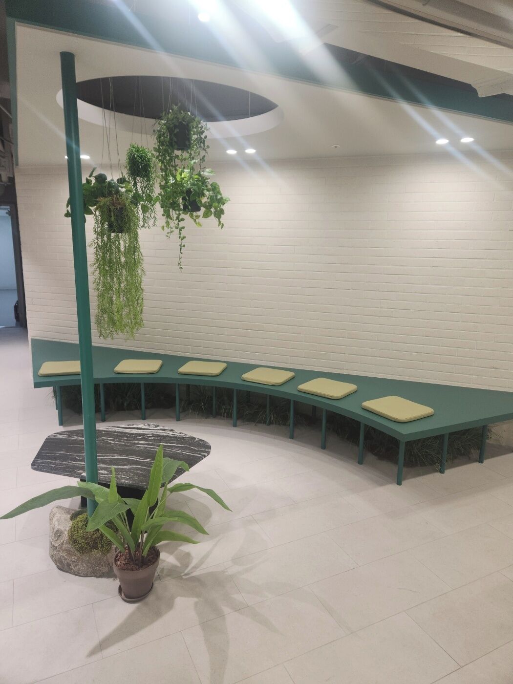 A seating area with a curved bench and potted plants.