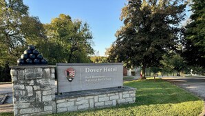 A sign for the Dover Hotel at Fort Donelson National Battlefield, with a stone base and a logo of the National Park Service.