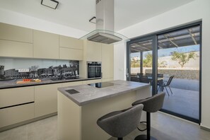 Enjoy meals in this kitchen with a sink, large window, and stainless steel oven.