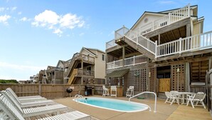 A pool area with lounge chairs and a barbecue grill. - 4744- Sandy Beaches, a spacious home in the heart of Kill Devil Hills! (Kitty Hawk)
