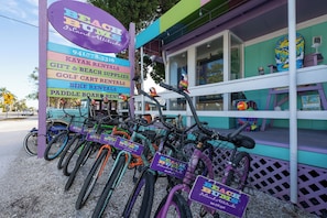 A colorful building with a sign listing services like kayak rentals and gift & beach supplies.