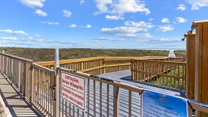 A wooden boardwalk with a sign warning against dragging chairs and other items that could damage mats. - Experience Beachfront Luxury w/ Spectacular Views! Pool & Hot Tub (South Padre Island)
