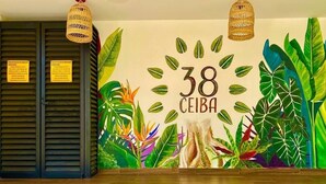 A wall with a number '38' and the word 'CEIBA' surrounded by tropical foliage. - 2BR Apt + Rooftop Pool | Steps to 5th Avenue (Playa del Carmen)