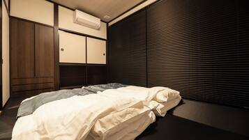 Ein Hotelzimmer mit Bett, Kleiderschrank und einem Fenster mit Jalousien.