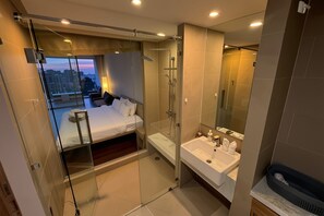 A modern hotel room with a glass-enclosed balcony, a separate shower area, and a large mirror. - Ark Studio only 10 Minutes from kata/Karon Beach (Karon)