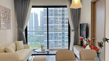 Family Apartment, Balcony, City View | Living area | Flat-screen TV