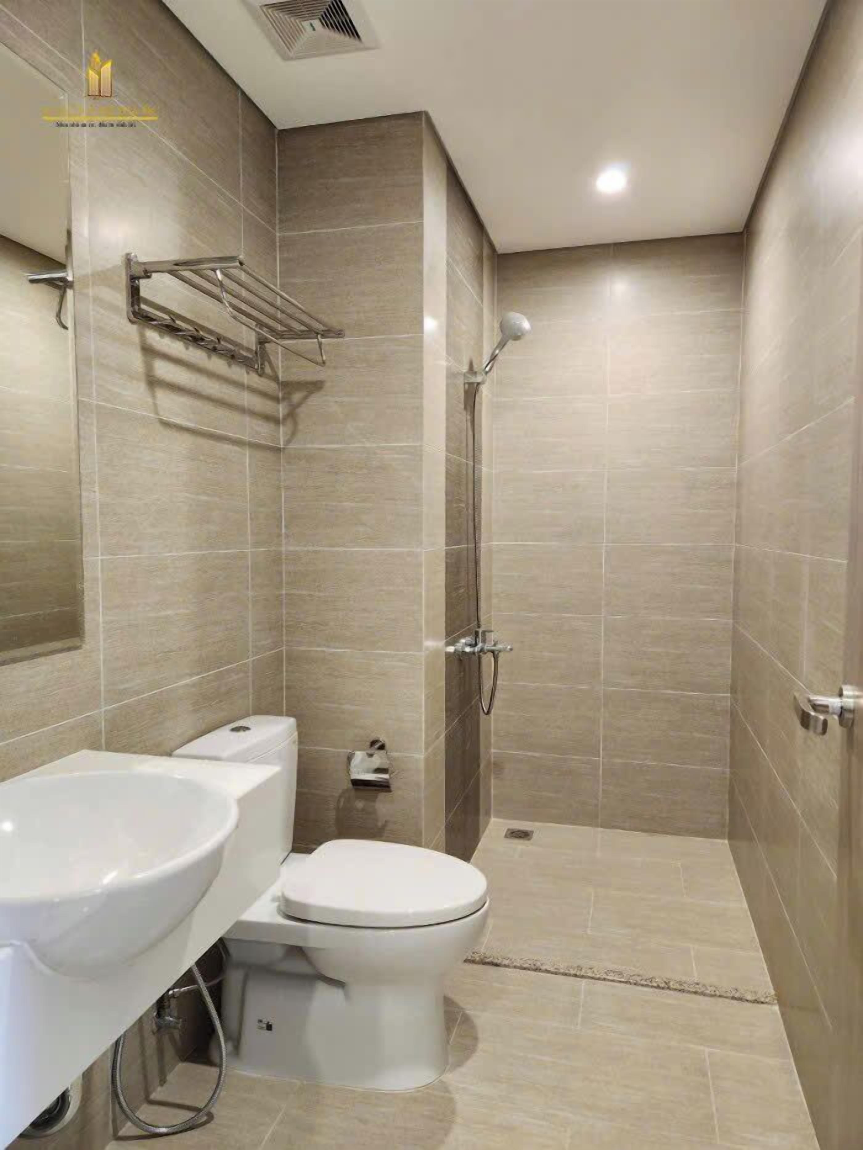 A modern bathroom with a toilet, bidet, and shower.