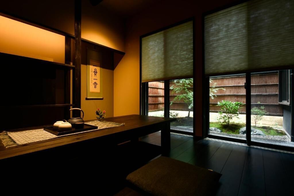 A traditional Japanese room with tatami flooring, a low wooden table, and sliding shoji doors.