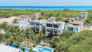 A resort with modern architecture, a pool, and a view of the ocean. - Villa · Private Pool · Ocean View · Isla Mujeres (Isla Mujeres)