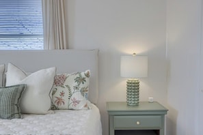 A neatly made bed with pillows, a bedside lamp, and a nightstand. - Mountain Sunrise Retreat (Spring Glen)