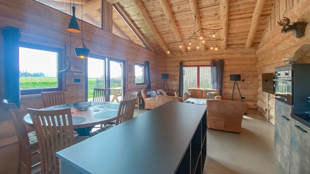 A log cabin interior with a dining area, sofa, and kitchen. - 3 bedroom lovely home in Den Oever (Den Oever)