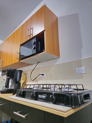 Fridge, microwave, stovetop, coffee/tea maker