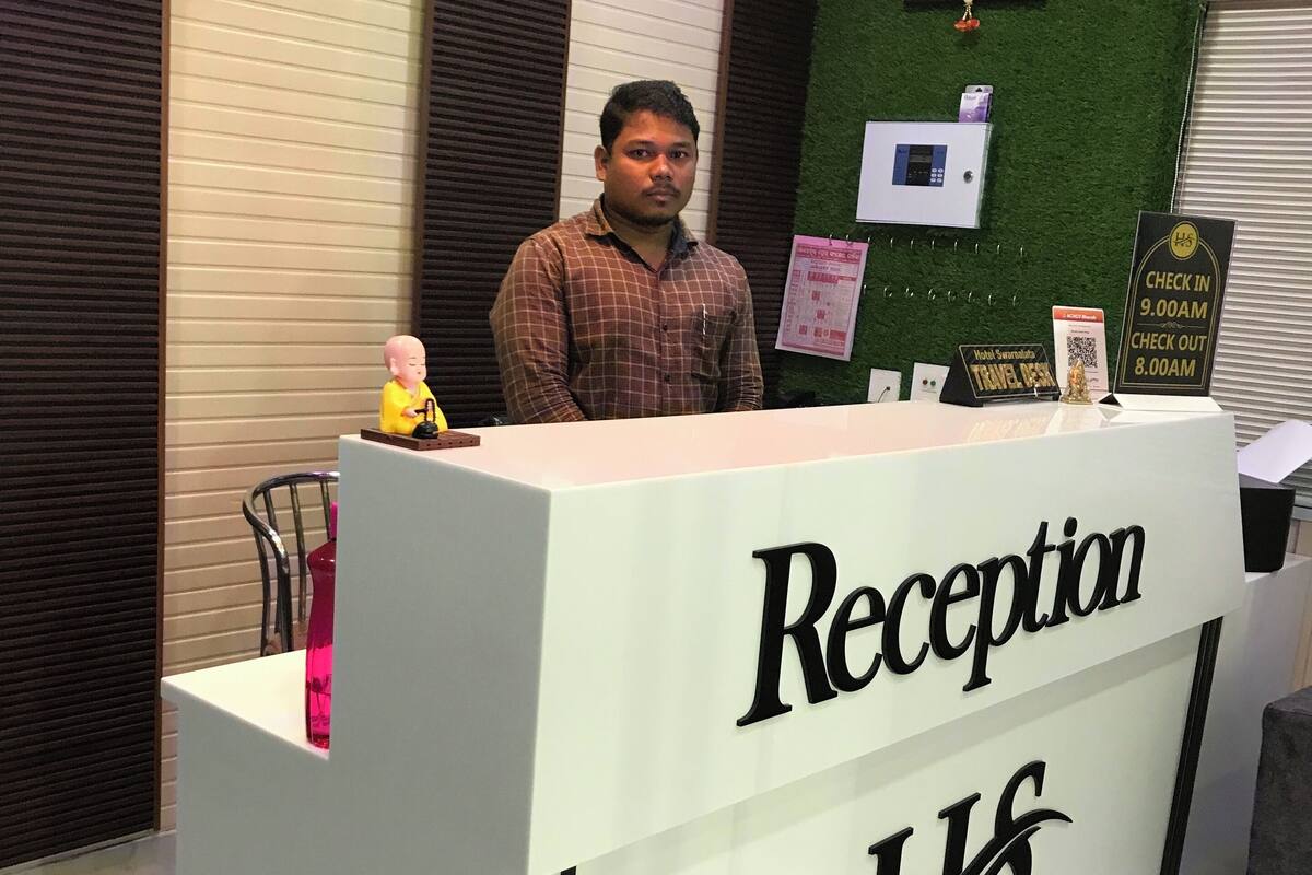 A reception desk with a sign reading "Reception" and "LHS".