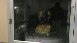 A glass-fronted cabinet with floral patterns on the sides and a reflective surface on top. - Hotel Swarna Lata (Puri)