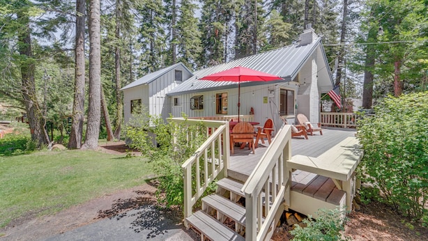 A cabin with a deck, outdoor seating, and a red umbrella. - < 2 Blocks to Lake Tahoe: Family Home Near Skiing (Homewood)