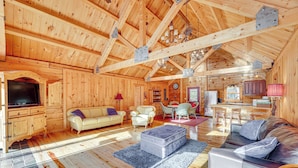 A spacious log cabin interior with a living room, dining area, and kitchen. - 15 Mi to Snowshoe Resort: Cabin w/ Deck & Fire Pit (Dunmore)