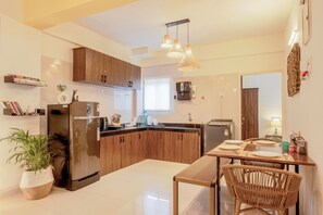 Fridge, electric kettle, dining tables
