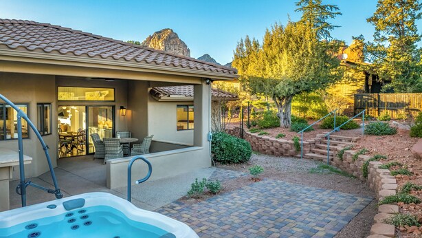 A house with a patio, outdoor seating, a hot tub, and a landscaped garden. - Carefree on the Rocks  - West Sedona location with a hot tub.  (Sedona)