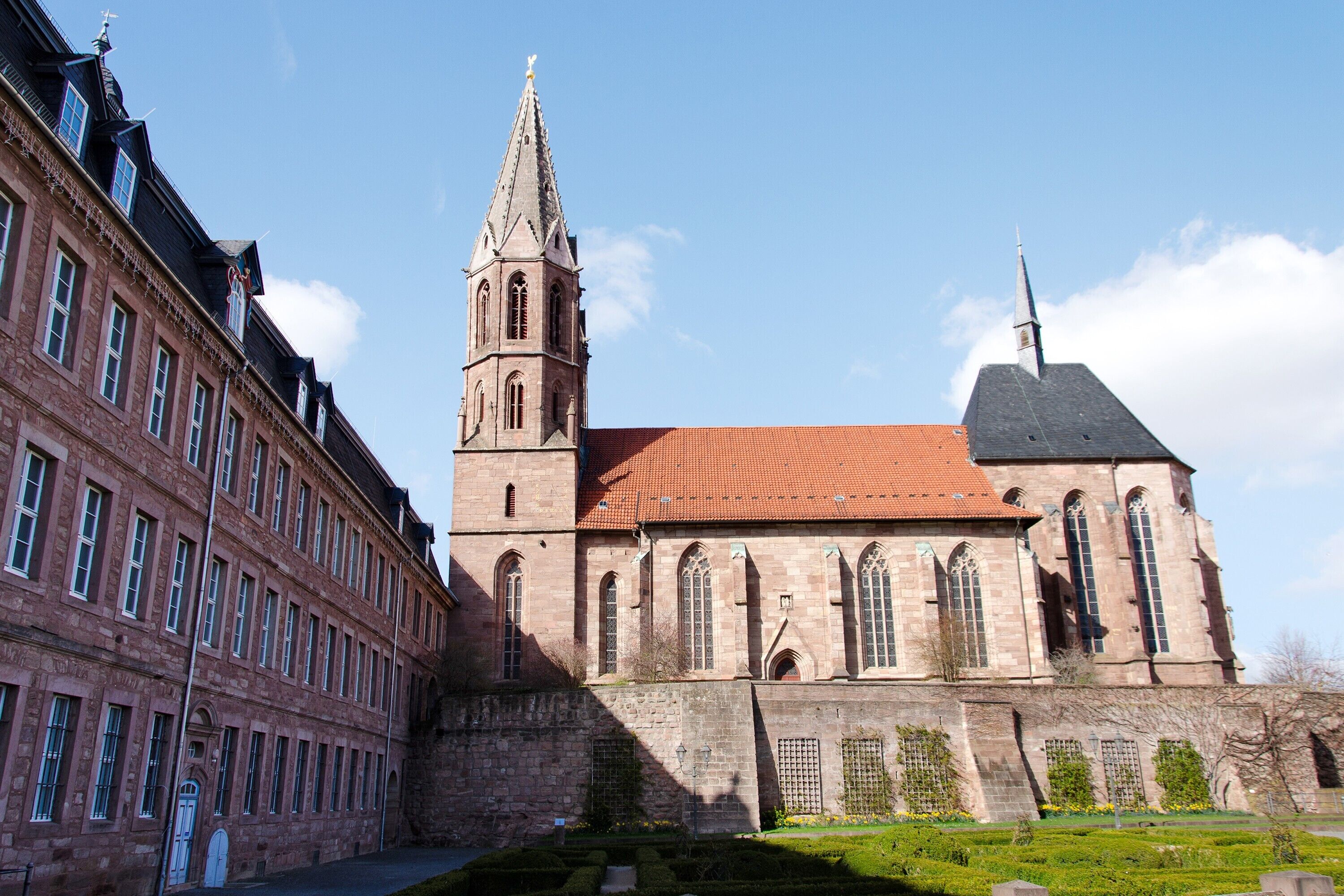A historic building with a prominent tower and a large arched entrance.