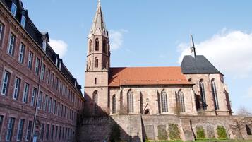 A historic building with a prominent tower and a large arched entrance.