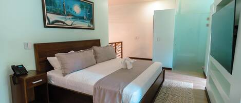 A bedroom with a bed, nightstand, and a painting on the wall.