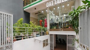 A modern building with a glass storefront displaying clothing. - Ha Noi Memory Apartel (Hanoi)