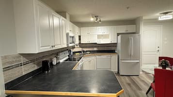 Deluxe Apartment, Kitchen, Ground Floor | Private kitchen | Coffee/tea maker, electric kettle
