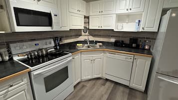 Deluxe Apartment, Kitchen, Ground Floor | Private kitchen | Coffee/tea maker, electric kettle