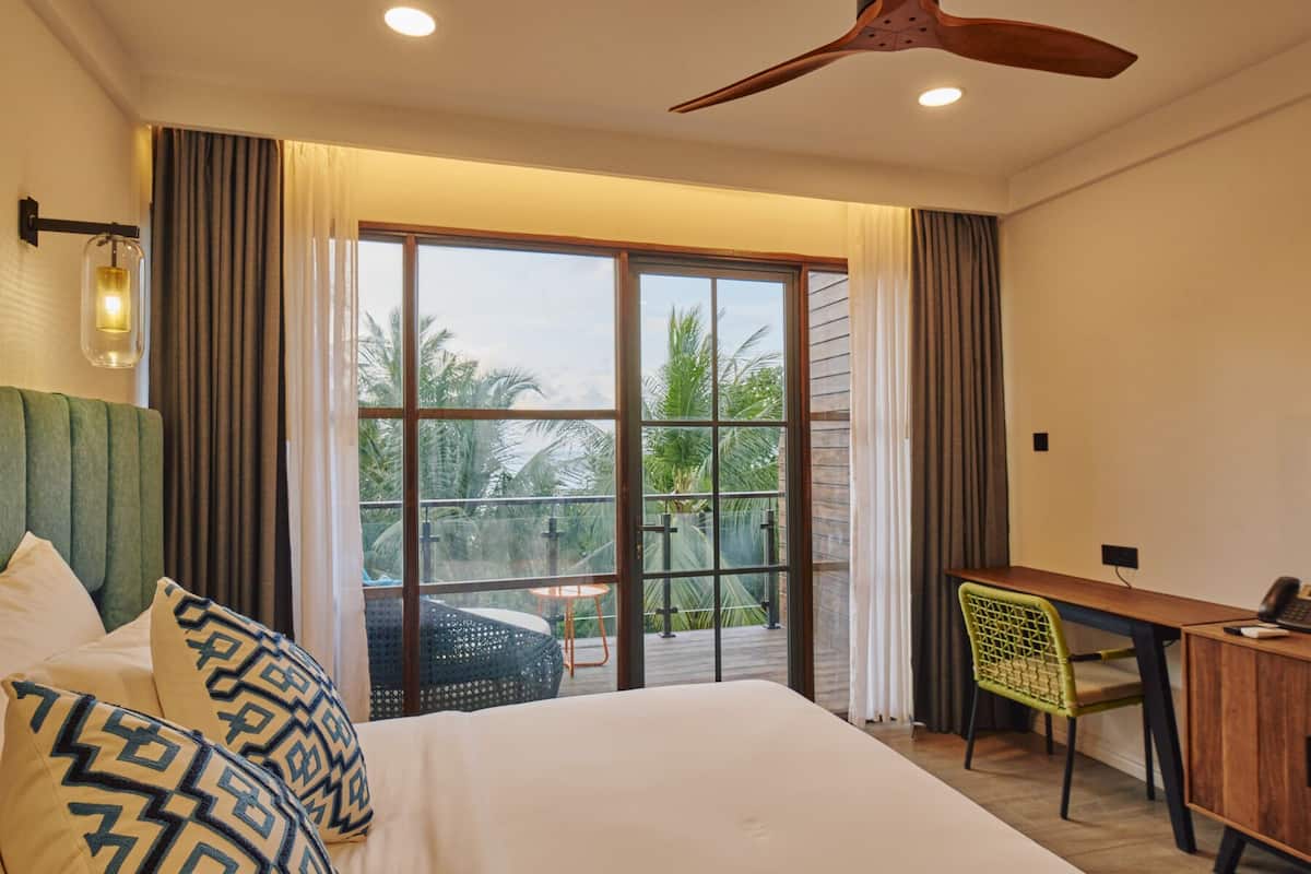 Deluxe Double Room, Balcony, Beach View | Minibar, in-room safe, desk, soundproofing
