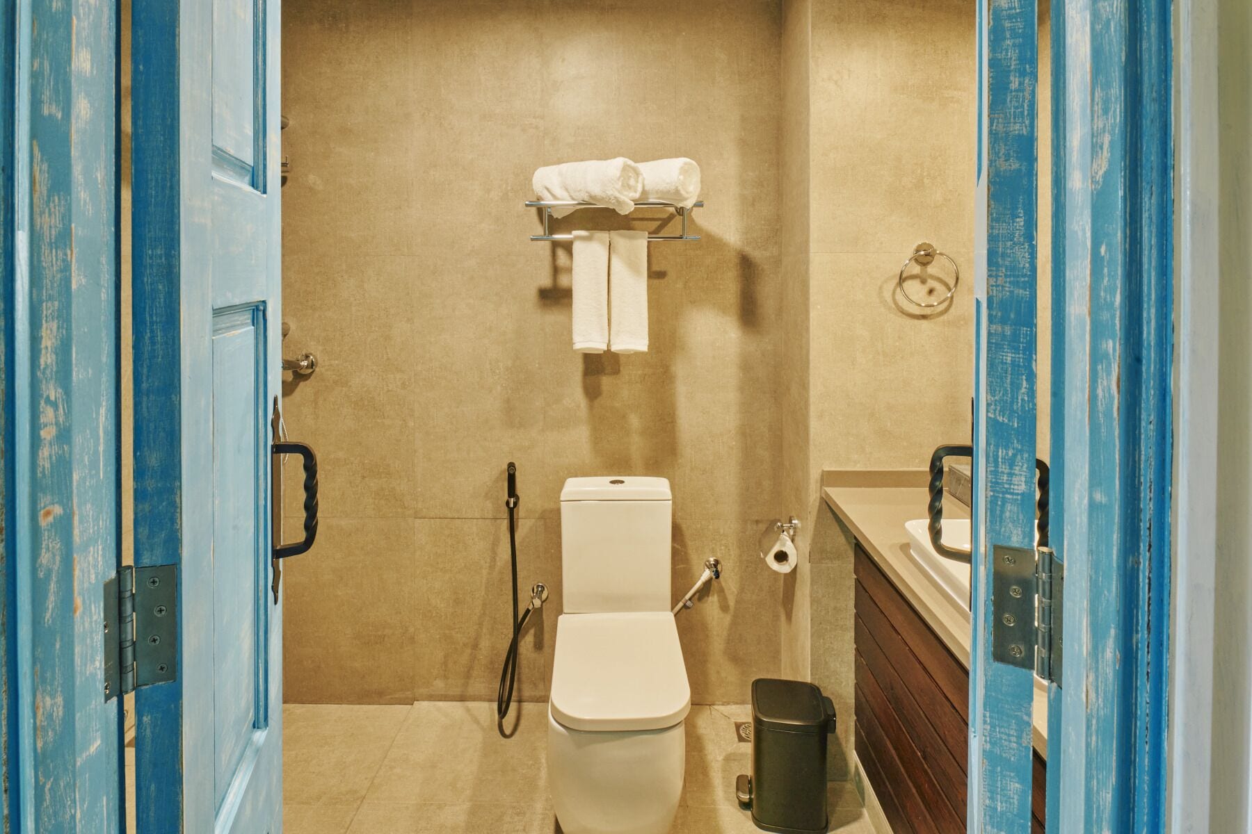 A bathroom with a toilet, a shower, and a sink.