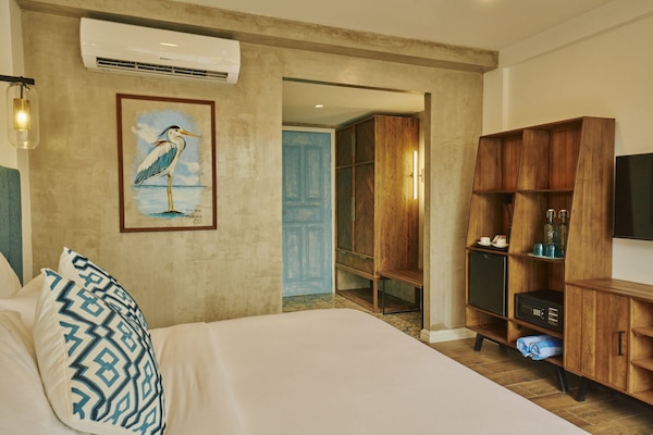 Deluxe Double Room, Balcony, Beach View | Minibar, in-room safe, desk, soundproofing
