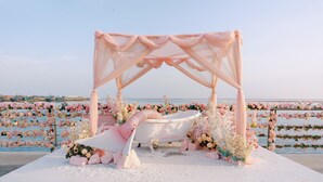 A romantic outdoor setting with a canopy, a bathtub, and floral arrangements. - Tangchi Seaview Resort (Weihai)
