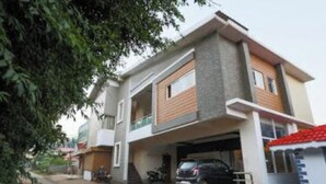 A two-story residential building with a garage and a covered parking area. - SRJ Thaneesh Residency (Ootacamund)