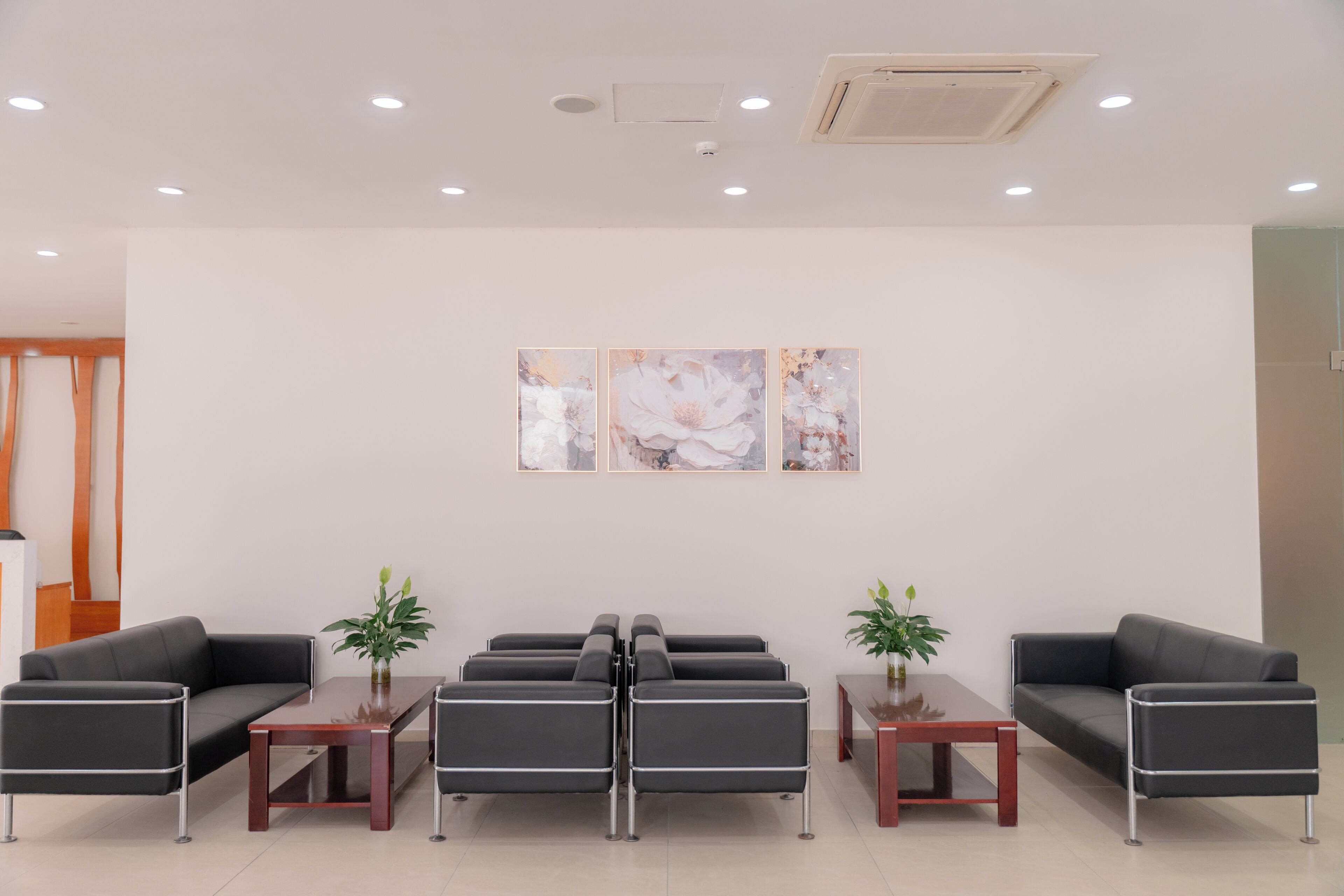 A modern waiting area with a sofa, chairs, and a coffee table.