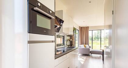 The six-person holiday villa Amalia with private sauna has a spacious living room, open kitchen, three bedrooms and a spacious patio.