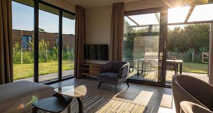 The Amalia is a 4-person holiday home featuring a cozy, homely living room with an open kitchen, 2 bedrooms, a spacious outdoor area, and a hot tub.