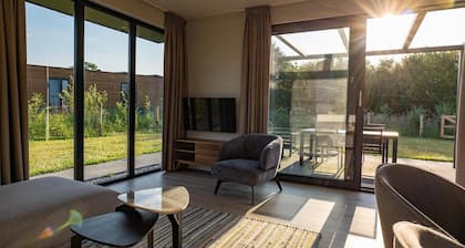 This holiday home with a private sauna and hot tub features a cozy, homely living room with an open kitchen, 2 bedrooms, and a spacious outdoor area