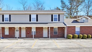 A two-story motel with a parking lot in front.