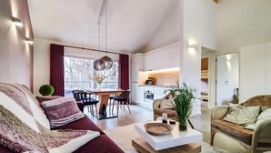 A modern living room with a sofa, a coffee table, and a dining area with chairs and a table. - Stunning home in Somme-Leuze with WiFi (Somme-Leuze)