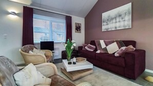 A living room with a sofa, chairs, a coffee table, and a TV. - Stunning home in Somme-Leuze with WiFi (Somme-Leuze)