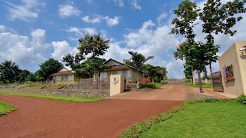 A residential area with houses, a paved road, and a clear sky.