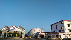 A building with a sign reading "MAA PARADISE WORLD" and a dome structure in the background. - Maa Paradise World (Alipurduar)