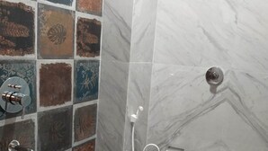 A bathroom with a shower, a toilet, and a sink. - Maa Paradise World (Alipurduar)